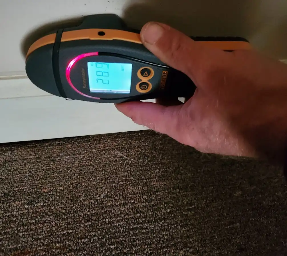 Moisture detection at baseboard during Storm Damage Restoration in Patchogue